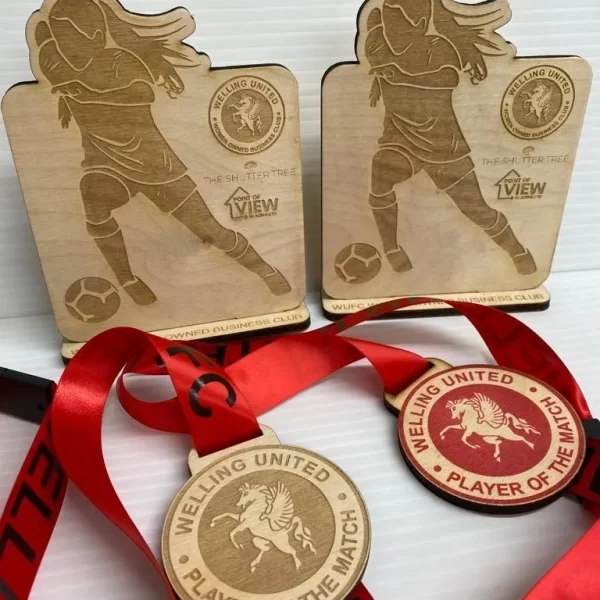 Two football medals with ribbons, made of wood.