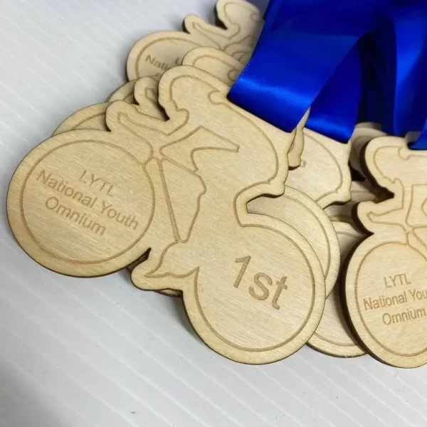 A group of wooden cycling medals with blue ribbons.