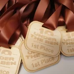 A group of wooden medals with the words under the ben.