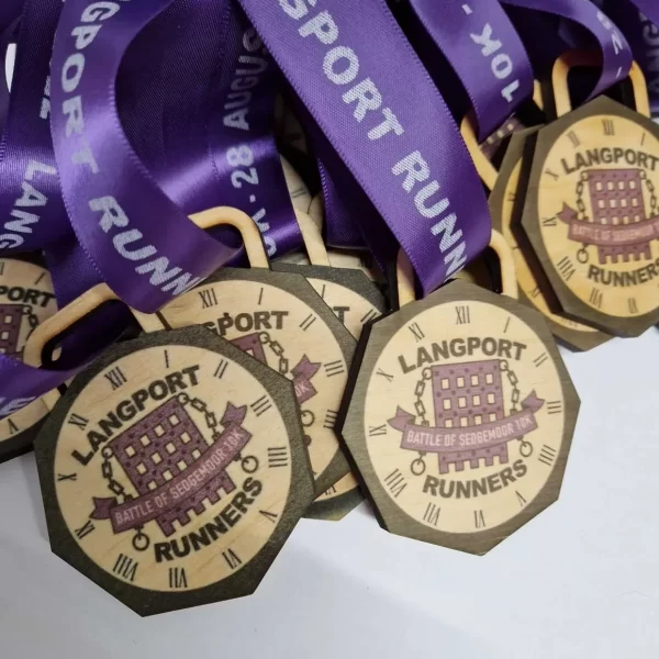 A collection of running medals with purple ribbons.