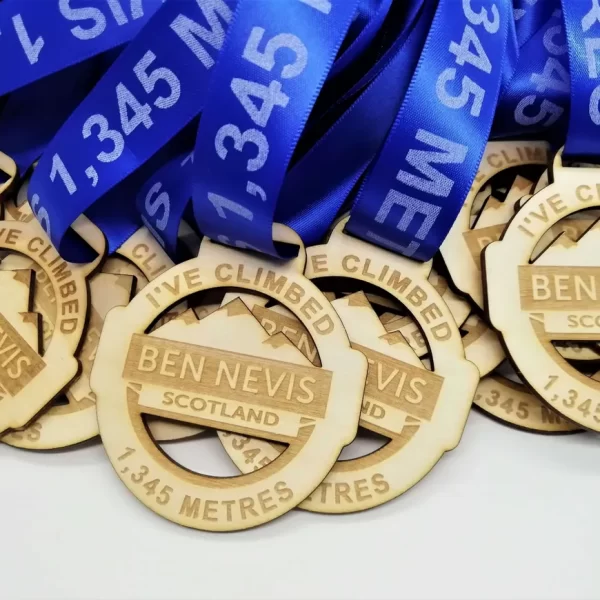 A group of climbing medals with blue ribbons.
