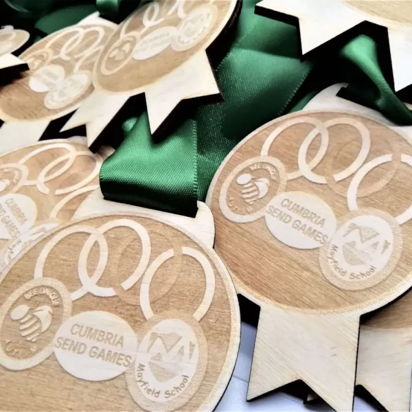 Sports Day Medals, comprising wooden medals with green ribbons.