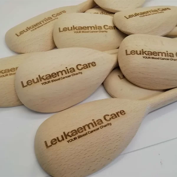 A collection of wooden spoons adorned with the words "lukenin care" engraved onto them.