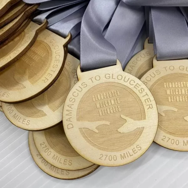 A group of running medals on a white surface.