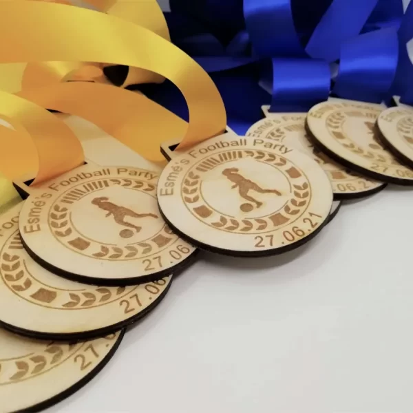 A group of Football Medals with blue and yellow ribbons.