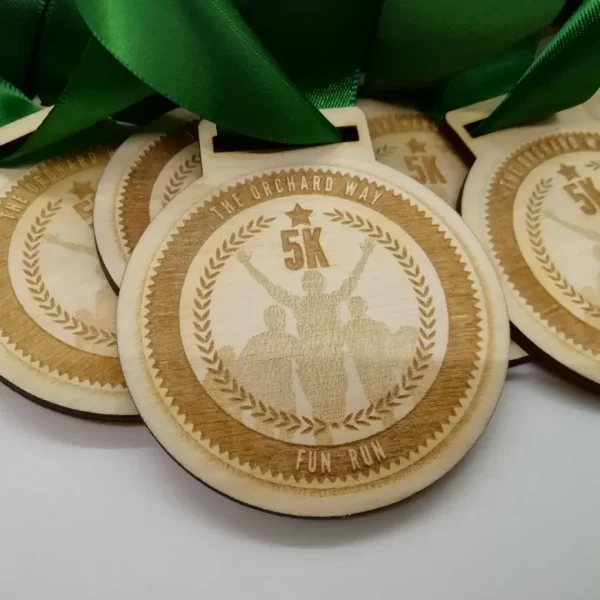 A group of Sports Day medals with green ribbons.