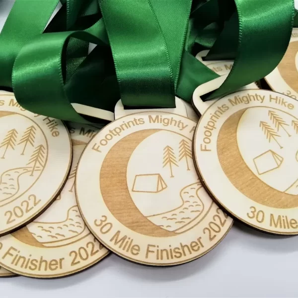 A collection of running medals with vibrant green ribbons.