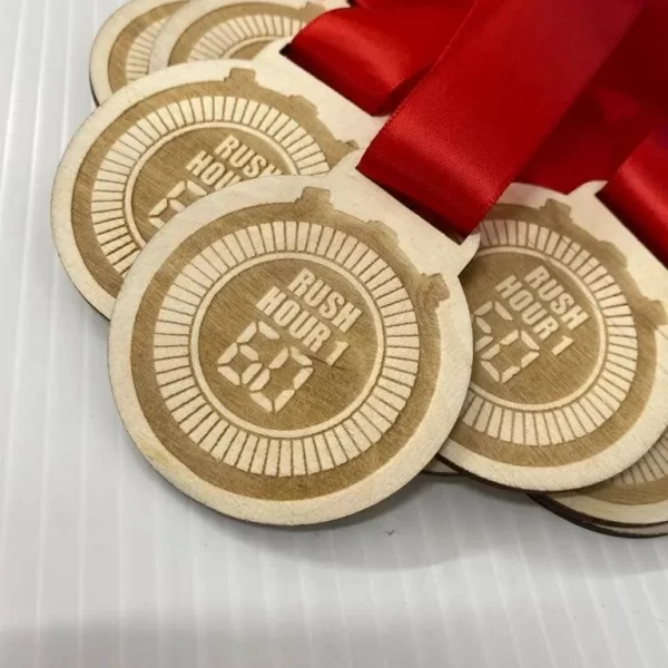 Five wooden climbing medals with red ribbons.