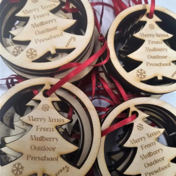 Personalised wooden Christmas tree ornaments featuring sports day medals.