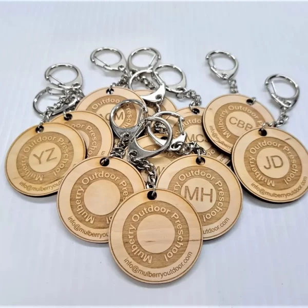 A collection of wooden keychains personalized with names for Sports Day participants, serving as a delightful alternative to traditional medals.