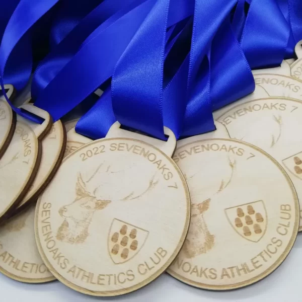 A collection of running medals with blue ribbons.