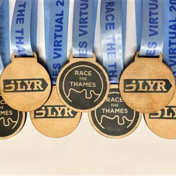 Five wooden sailing medals with the word 'survivor' on them.