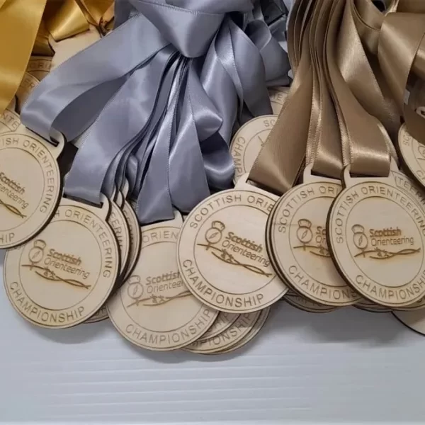 A group of climbing medals decorated with vibrant ribbons.