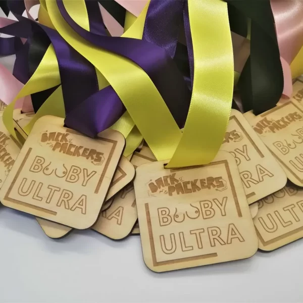 A collection of running medals showcasing wooden designs and accompanying ribbons.