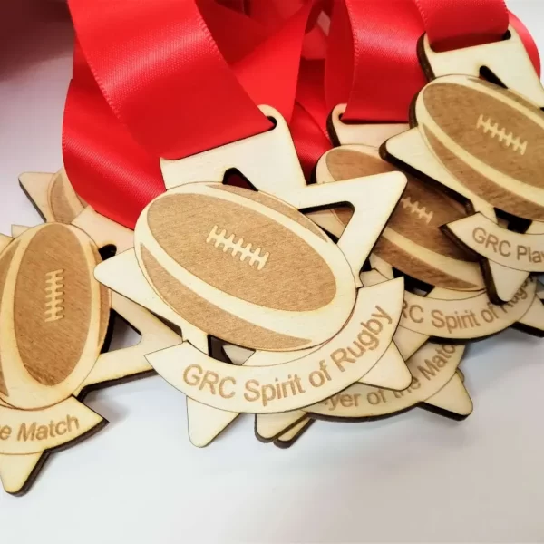 A collection of football medals crafted from wood.