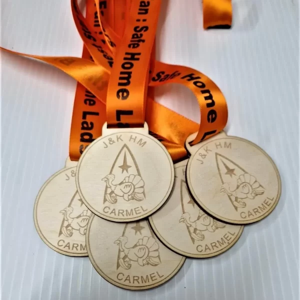 Four running medals with orange ribbons.