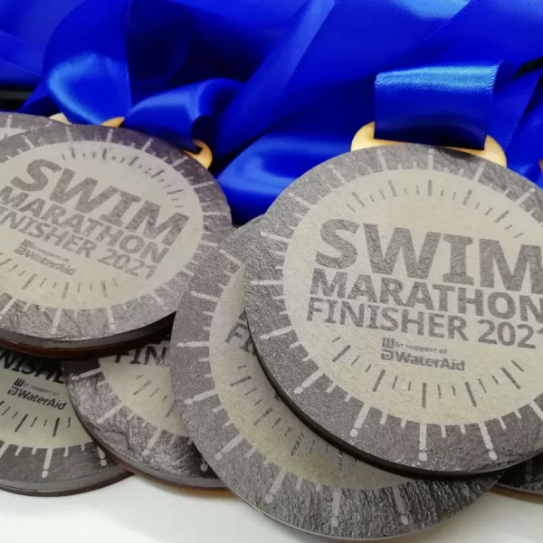 A group of Swimming Medals with the words swim marathon finisher 2021.