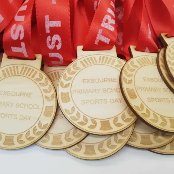 A group of Sports Day medals with red ribbons.