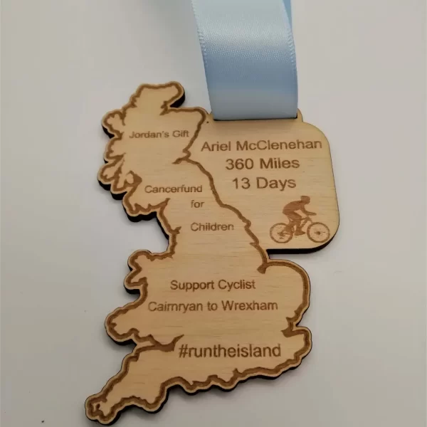 A wooden cycling medal with a blue ribbon and a map of England.