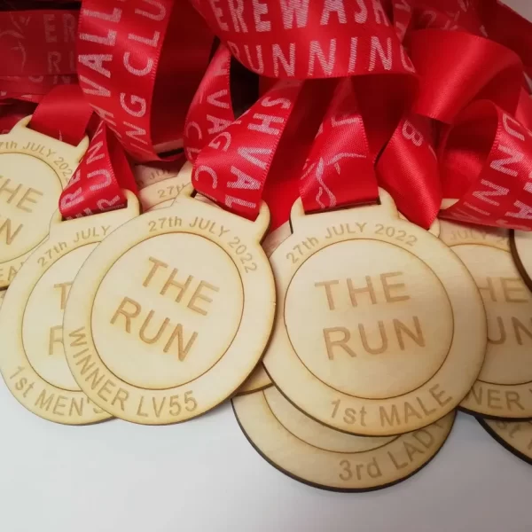 A group of wooden medals with the words "the run" on them.