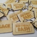 A group of wooden key tags that say birthday bash.