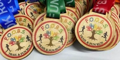 A group of Eco Medals with the word fobs on them.
