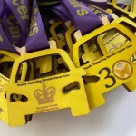 A group of medals with a purple ribbon on them.