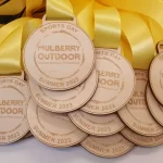 A group of medals with a yellow ribbon.
