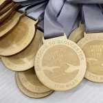 A group of wooden medals on a white surface.