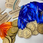 A group of medals and ribbons on a table.
