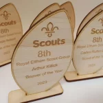 Four wooden scout awards with the word scouts on them.