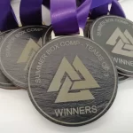 A group of medals with purple ribbons on them.