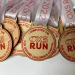 A group of medals with the word ox5 run on them.