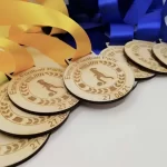 A group of medals with blue and yellow ribbons.