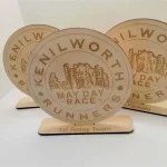 Three wooden plaques with the words kennworth mayday race runners.