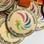 A group of medals with the words silver medal winner.