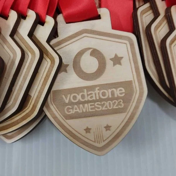 Wooden medals with red ribbons.