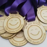 A group of wooden medals with a smiley face on them.