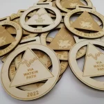 A group of wooden medals with a design on them.