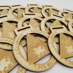 A set of wooden medals with a horse on them.