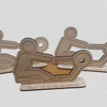 Three eco-friendly wooden plaques with a person riding a bike, resembling medals.