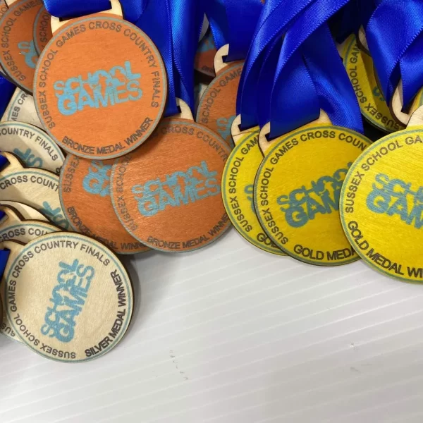 A collection of colourful medals featuring vibrant blue ribbons.