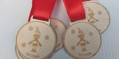 Four custom wooden medals with red ribbons.