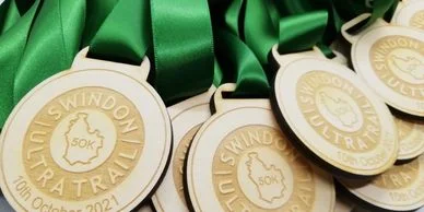 Custom medals with green ribbons.