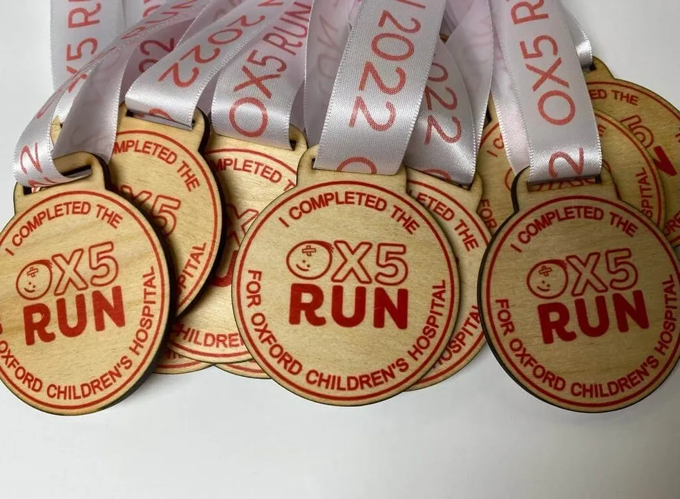 A group of colourful medals with the word ox5 run on them.