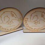 Two wooden plaques with a logo on them.