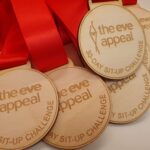 A group of wooden medals that say the eve appeal.