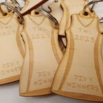 A group of wooden keychains with a dress on them.