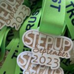 A pile of green ribbons with the words step up.