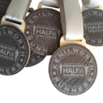 A group of medals with the word Half Marathon written on them.